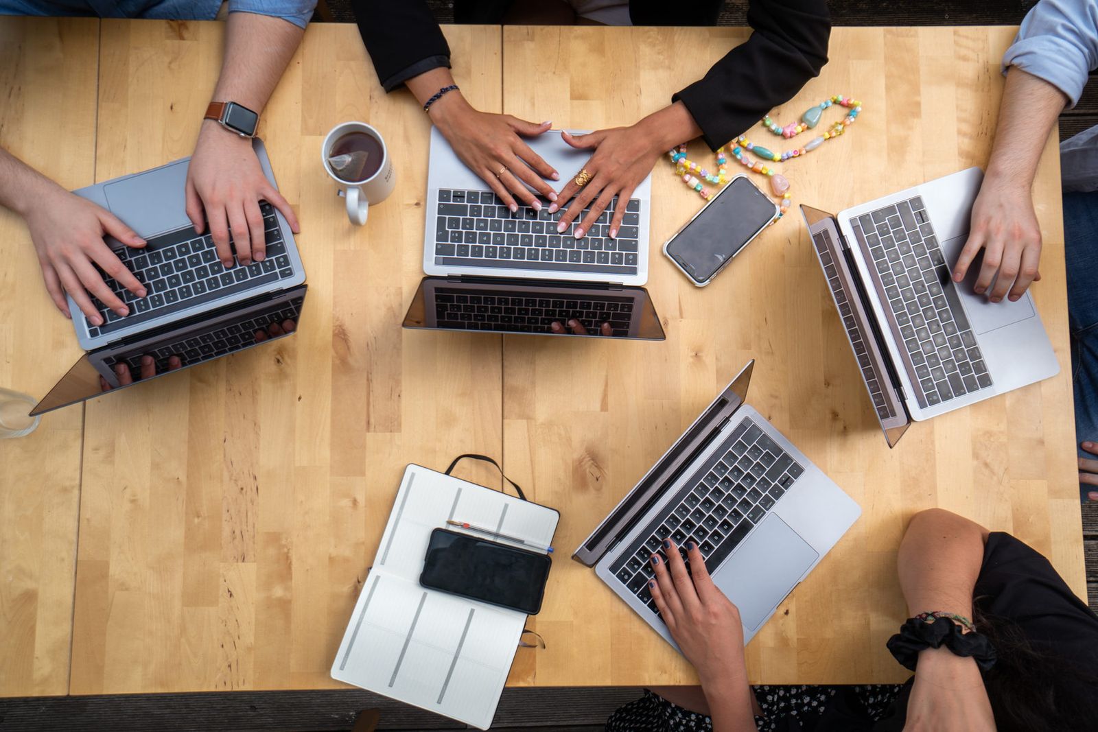Team coordinating a project on laptops